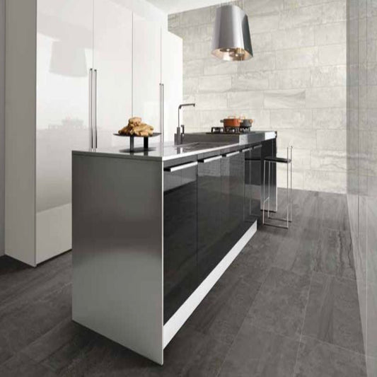 Modern kitchen with a sleek island and tiled walls.